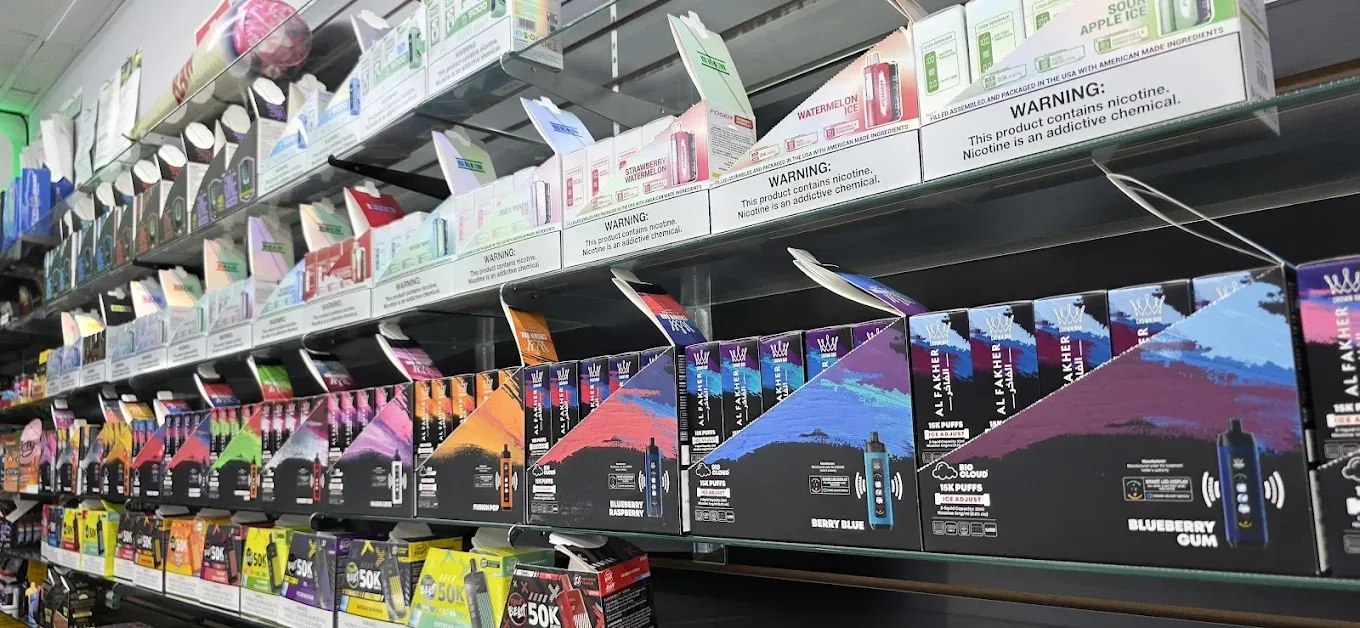 Disposable vape products on display shelf at Smokey Houston